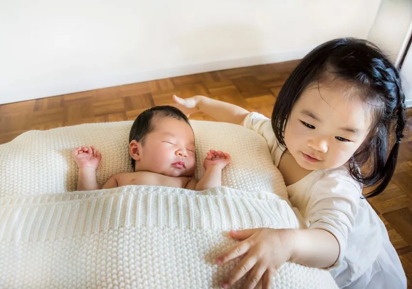 A toddler with her brother